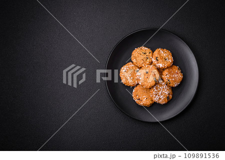 Delicious sweet round sponge cookies sprinkled with coconut flakes Delicious sweet round sponge cookies sprinkled with coconut flakes 109891536
