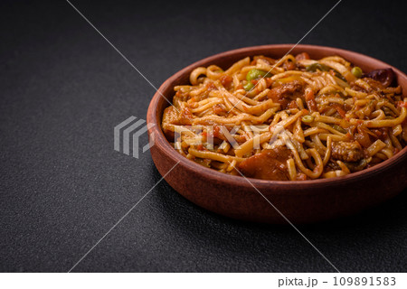Delicious asian udon dish with vegetables, mushrooms, salt and spices Delicious asian udon dish with vegetables, mushrooms, salt and spices 109891583