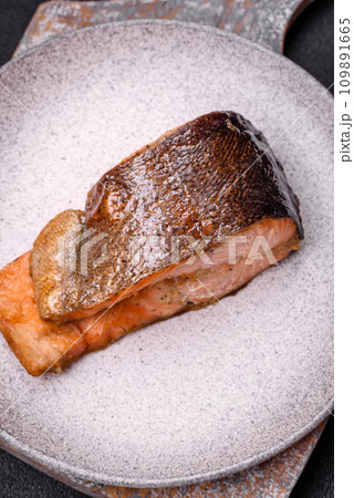 Fresh cooked delicious salmon steak with spices and herbs baked on a grill 109891665