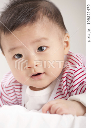 asian baby boy lying on bed asian baby boy lying on bed 109893470