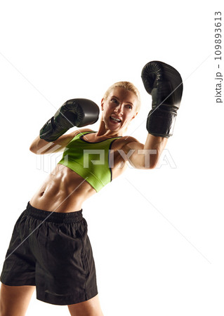 Upper cut punch. Young woman with muscular fit body training, boxing athlete practicing isolated over white background. Sport, healthy and active lifestyle Upper cut punch. Young woman with muscular fit body training, boxing athlete practicing isolated over white background. Sport, healthy and active lifestyle 109893613
