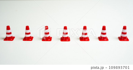 Row of traffic cones on a white background. Create a new restriction. Provide new sanctions and restrictions. Laws and regulations. Bans and taboo. Stop work, freeze and cancel. Block VPN services. Row of traffic cones on a white background. Create a new restriction. Provide new sanctions and restrictions. Laws and regulations. Bans and taboo. Stop work, freeze and cancel. Block VPN services. 109893701