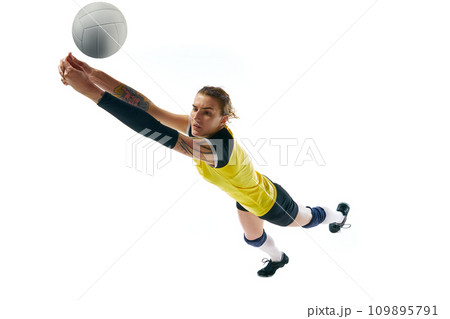 Dynamic competitive young woman, volleyball player in motion during game, hitting ball isolated over white background. Sport, active and healthy lifestyle 109895791