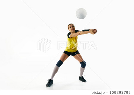 Dynamic competitive young woman, volleyball player in motion during game, hitting ball isolated over white background. Sport, active and healthy lifestyle Dynamic competitive young woman, volleyball player in motion during game, hitting ball isolated over white background. Sport, active and healthy lifestyle 109895793