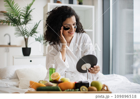 Pretty lady keeping morning skincare routine in bedroom. 109896518