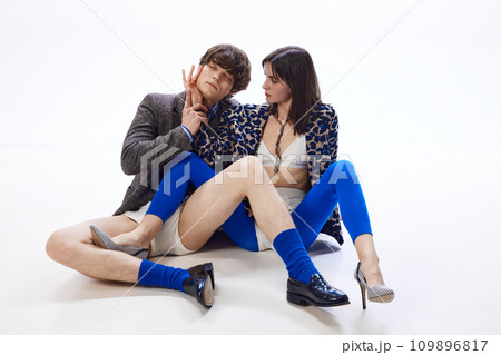 Full length portrait of young man put hand of his beloved girl to her face and closed his eyes with pleasure and enjoyment. 109896817