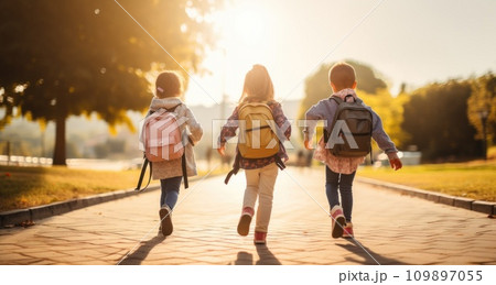 young kids with backpacks walking on the road young kids with backpacks walking on the road 109897055