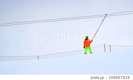 Person skiing down a slope, winter entertainment, winter time. Copy space. Selective focus 109897828