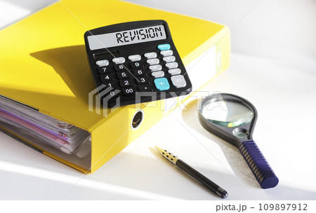 Calculator with the word REVISION. Business concept for the act of reviewing someone 109897912