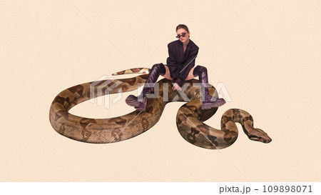 Contemporary art collage. Elegance and beauty in wild. Young cool attitude girl sitting on huge snake, python against peach color background. 109898071
