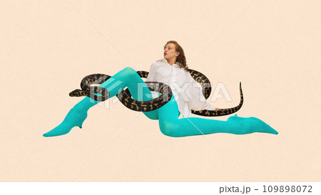 Contemporary art collage. Weird woman in white blouse and blue tights sitting with snake in her legs against peach color background. Contemporary art collage. Weird woman in white blouse and blue tights sitting with snake in her legs against peach color background. 109898072