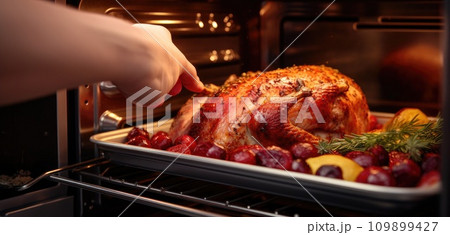 a person is pouring a roast out of an oven a person is pouring a roast out of an oven 109899427