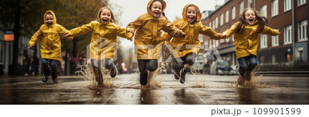 Happy joyful children running through puddles 109901599