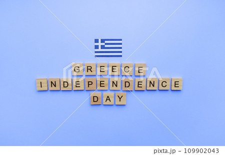 March 25, Independence Day in Greece, the flag of Greece, a minimalistic banner with an inscription in wooden letters March 25, Independence Day in Greece, the flag of Greece, a minimalistic banner with an inscription in wooden letters 109902043