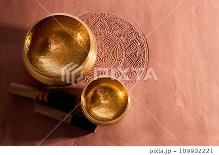A close up of a tibetan singing bowl or himalayan bowl for therapy, meditation and relaxation. A close up of a tibetan singing bowl or himalayan bowl for therapy, meditation and relaxation. 109902221