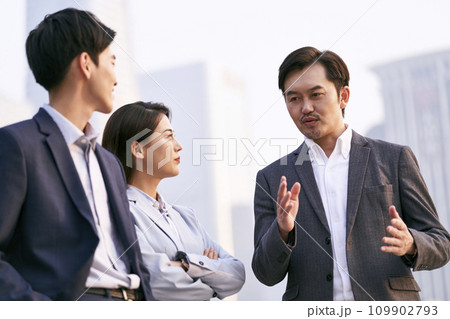 asian business people talking outdoors asian business people talking outdoors 109902793
