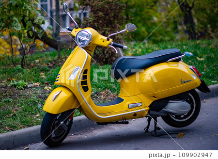 A yellow Vespa scooter in the courtyard of a residential building in the center of the Russian capital. A yellow Vespa scooter in the courtyard of a residential building in the center of the Russian capital. 109902947