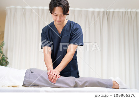 施術を行う若い男性整体師 施術を行う若い男性整体師 109906276
