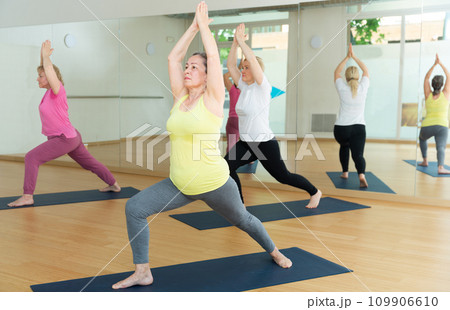 Women are doing warrior I pose 109906610