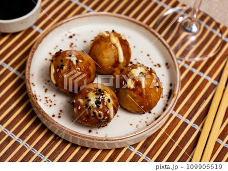 Takoyakis - octopus balls, popular Japanese snack closeup Takoyakis - octopus balls, popular Japanese snack closeup 109906619