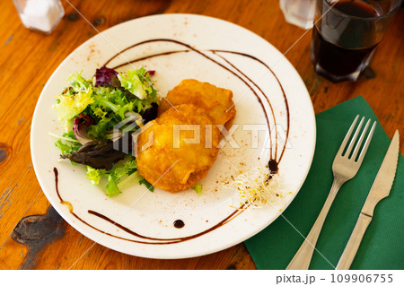 Potatoes stuffed with cod served on platter 109906755
