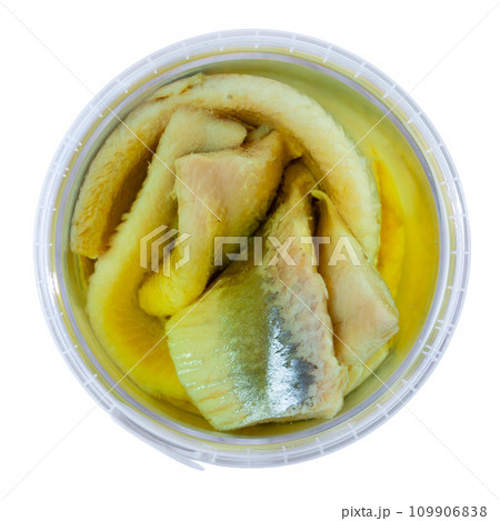 In plastic bucket containers are large pieces of salted herring fillet, freed from bones 109906838
