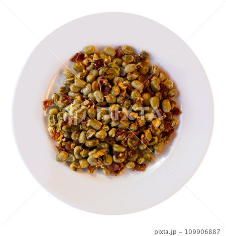 There is portion of fried beans with ham and scrambled eggs on plate 109906887