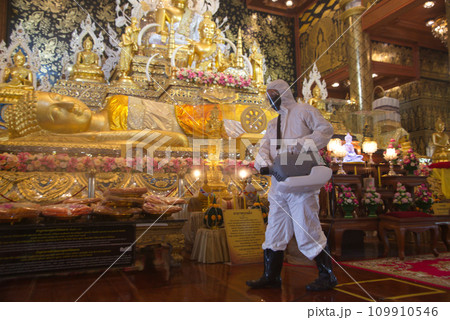 A male employee is spraying medicine to eliminate germs from a sprayer to eliminate Covid-19. At Wat Tha Mai temple. A male employee is spraying medicine to eliminate germs from a sprayer to eliminate Covid-19. At Wat Tha Mai temple. 109910546