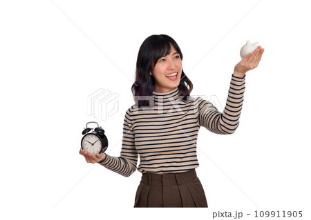 Happy Asian woman with sweater shirt holding alarm clock and piggy bank isolated on white background 109911905