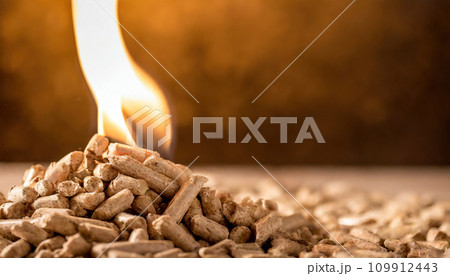Burning Elegance: Enchanting Flames Embrace Wood Pellet Pile Burning Elegance: Enchanting Flames Embrace Wood Pellet Pile 109912443