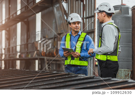 Professional engineer mechanic team working together in locomotive train deport work checking train spare parts in the locomotive maintenance shop. 109912630