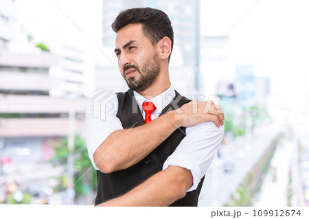 Hispanic indian business man shoulder pain arm muscle join cramp from office syndrome after hard working day. 109912674