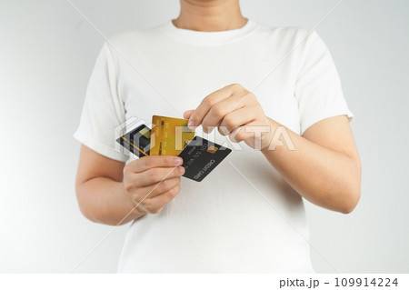 Female hand holds credit card and chooses to spend. 109914224