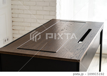Mobile phone with wireless charger on table. Modern workplace accessory Mobile phone with wireless charger on table. Modern workplace accessory 109915192