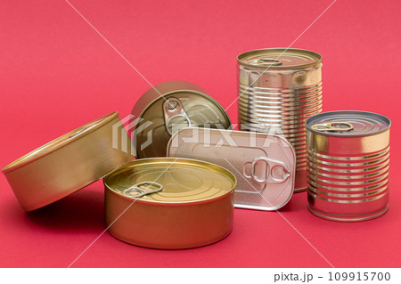 Unopened Tin Cans with Blank Edges on Red Background 109915700
