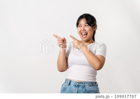 The cheerful young Asian woman has great thought, finding inspiration or solutions to solve a problem. pointing finger up standing on white background. 109917787