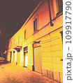 Old building with yellow streetlights in Lombardy, Italy, 2022. 109917790