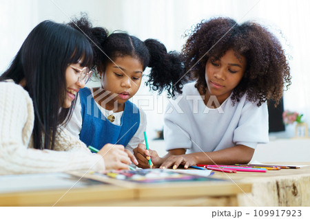 Happy joyful American - African ethnicity little girl learning and practicing drawing - painting. Happy joyful American - African ethnicity little girl learning and practicing drawing - painting. 109917923