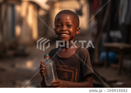 African boy with water bottle in hand. Black boy enjoying the water. African boy with water bottle in hand. Black boy enjoying the water. 109918882