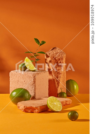 Fresh lemons and stone platforms are displayed together on a vibrant background of yellow and orange. Space for displaying cosmetics with natural ingredients. Fresh lemons and stone platforms are displayed together on a vibrant background of yellow and orange. Space for displaying cosmetics with natural ingredients. 109918974