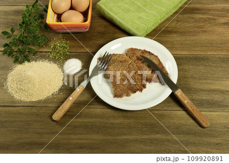 Veal milanese presented on the table with ingredients Veal milanese presented on the table with ingredients 109920891