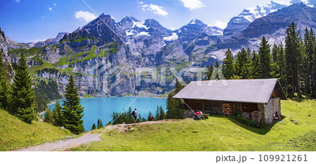 Idyllic swiss mountain lake Oeschinensee (Oeschinen) with turquise water and snowy peaks of Alps mountains near Kandersteg village. Switzerland nature and travel 109921261