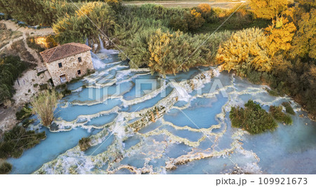 Most famous natural thermal hot spings pools in Tuscany - scenic Terme di Mulino vecchio ( Thermals of Old Windmill) in Grosseto province. Aerial drone view Most famous natural thermal hot spings pools in Tuscany - scenic Terme di Mulino vecchio ( Thermals of Old Windmill) in Grosseto province. Aerial drone view 109921673