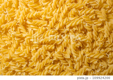 Uncooked Fusilli Pasta Background Uncooked Fusilli Pasta Background 109924200