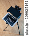 teleprompter for video. The reading text is reflected from the glass surface opposite the video camera lens 109925161