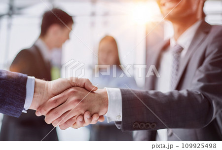 Close up of a handshake against college hallway Close up of a handshake against college hallway 109925498