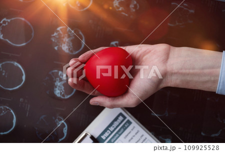 Red heart in the palm of your hand against the background of a medical card. cardiology concept 109925528