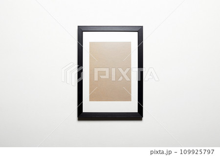 black picture frame on a wall. Stylish photoframe for poster or pictute. Empty frame for mock up black picture frame on a wall. Stylish photoframe for poster or pictute. Empty frame for mock up 109925797