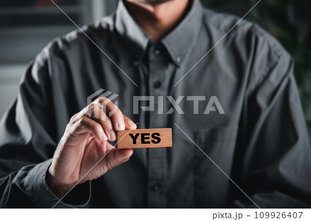 Businessman hands hold wooden blocks with yes and no words symbolizing decision-making. Choice signifying success in business. Think With Yes Or No Choice. Businessman hands hold wooden blocks with yes and no words symbolizing decision-making. Choice signifying success in business. Think With Yes Or No Choice. 109926407