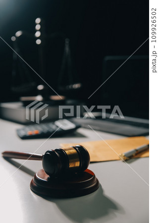 image of judge's hammer, scales lady of justice, law book, laptop computer and contract documents with pen concept of law and justice. 109926502